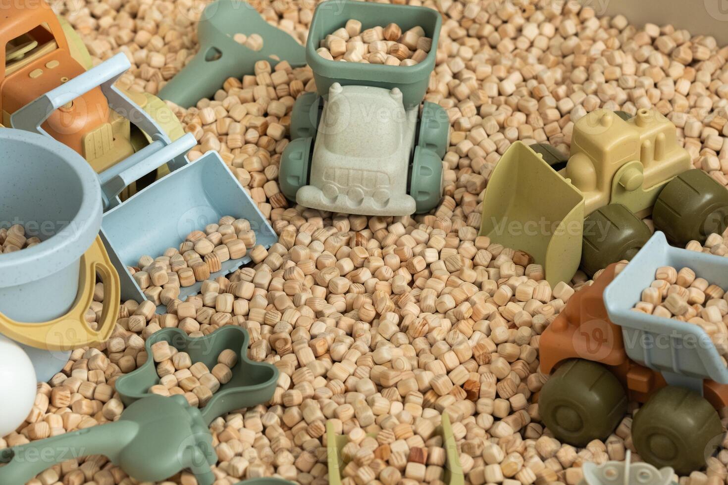 A modern children's sandbox with toys. Sandbox filler in the form of wooden small wooden cubes photo