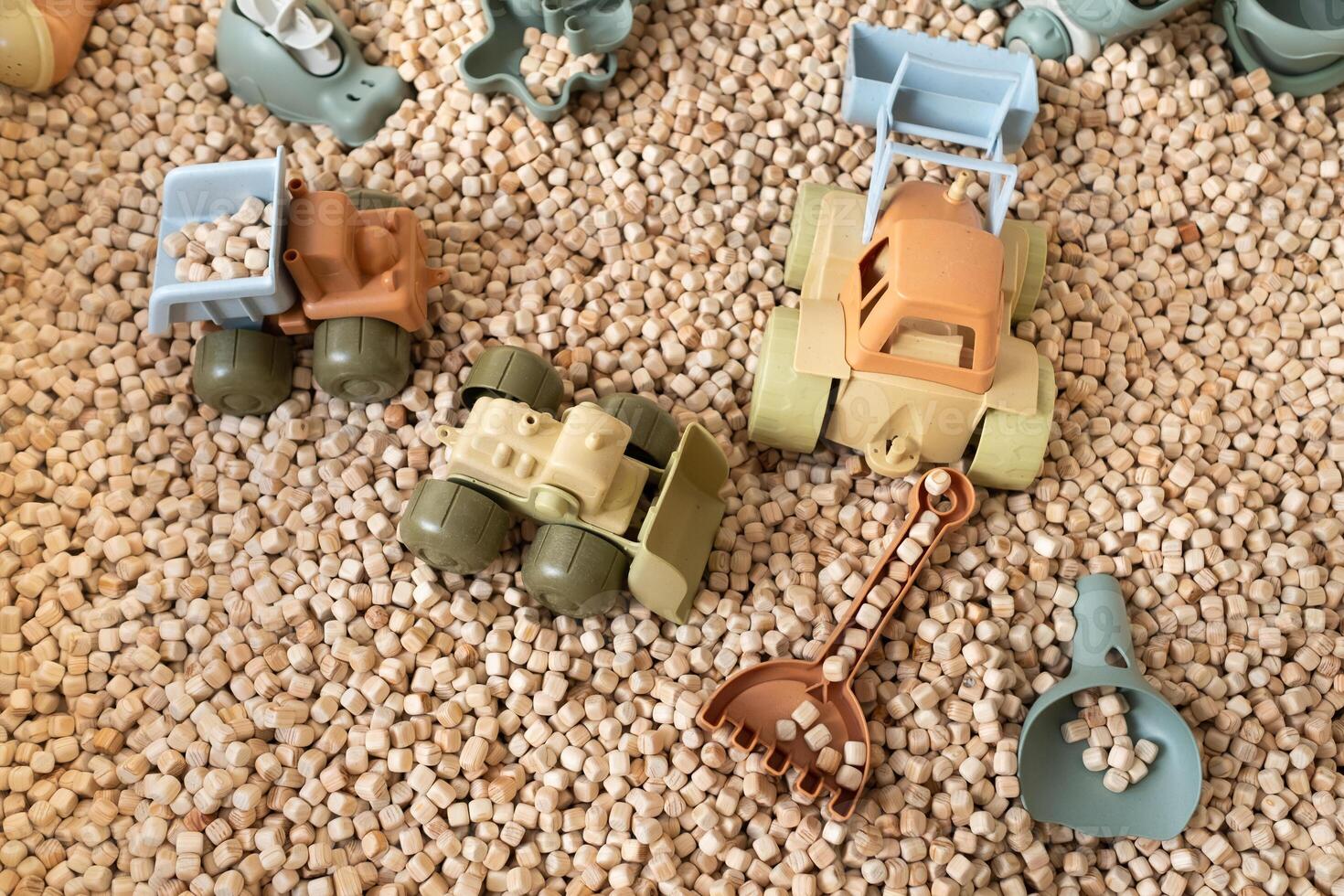 A modern children's sandbox with toys. Sandbox filler in the form of wooden small wooden cubes photo