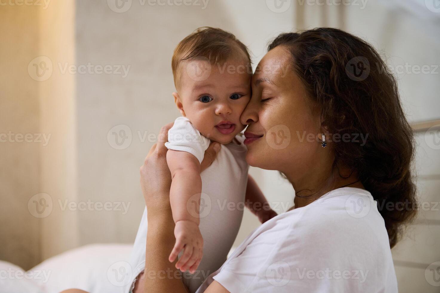 Delightful mother enjoys happy moments with her baby boy, cuddling him. Love. Tenderness. Happy Mother's Day concept photo