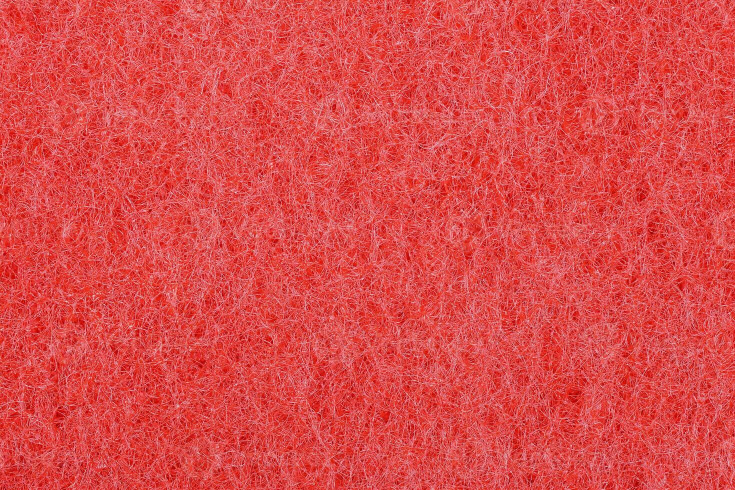 The red texture of the sponge is foam.The background of red foam. photo