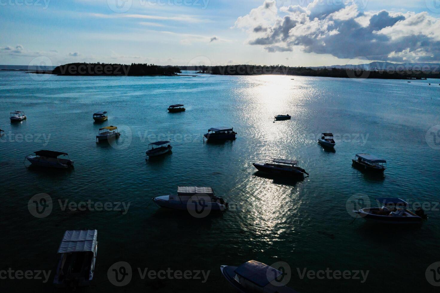 Aerial picture of the east coast of Mauritius Island. Beautiful lagoon of Mauritius Island shot from above. Boat sailing in turquoise lagoon photo