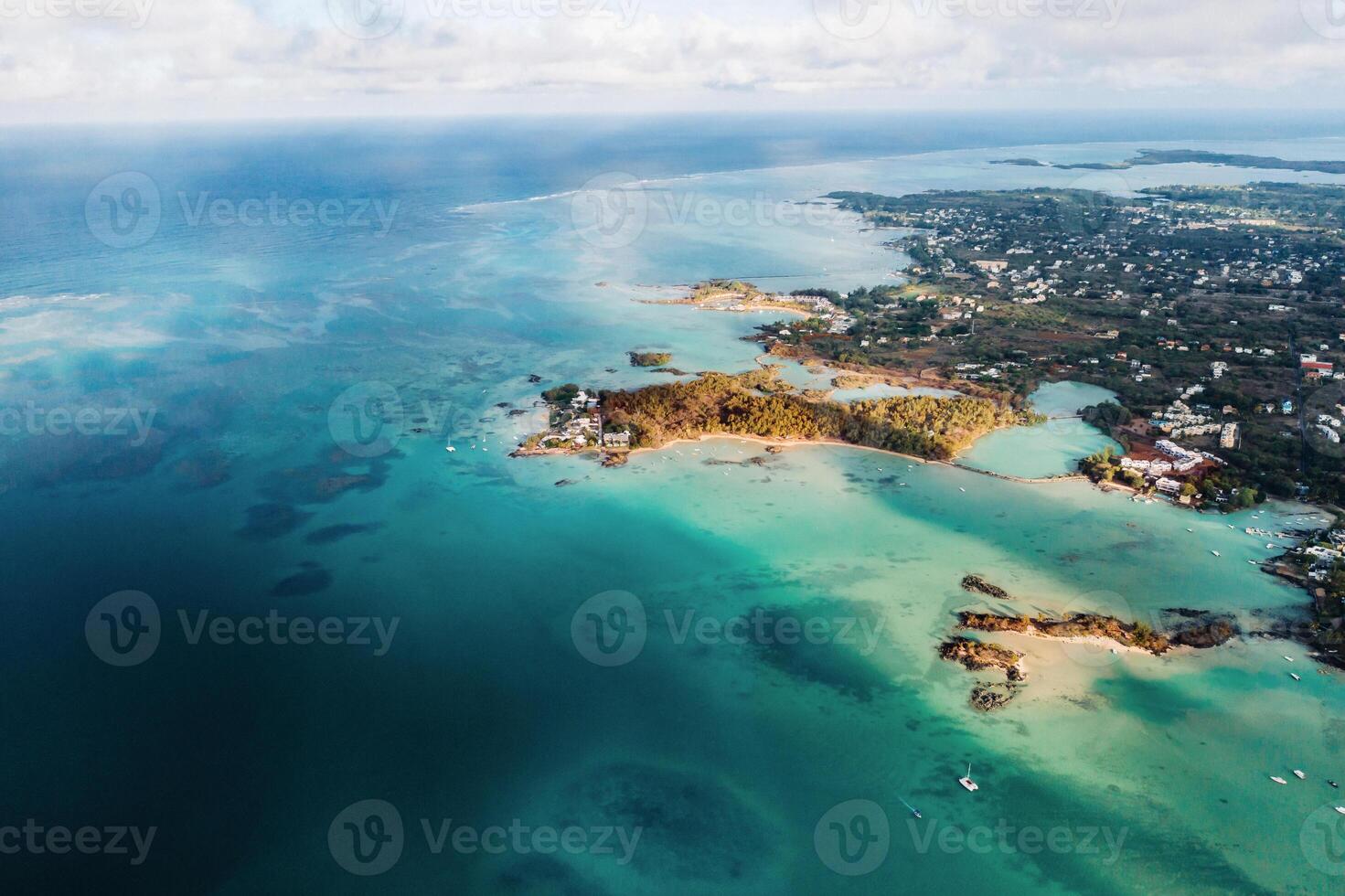 Aerial picture of the north, north east coast of Mauritius Island. Beautiful lagoon of Mauritius Island shot from above. Two catamaran boat and a speed boat sailing in turquoise lagoon. photo