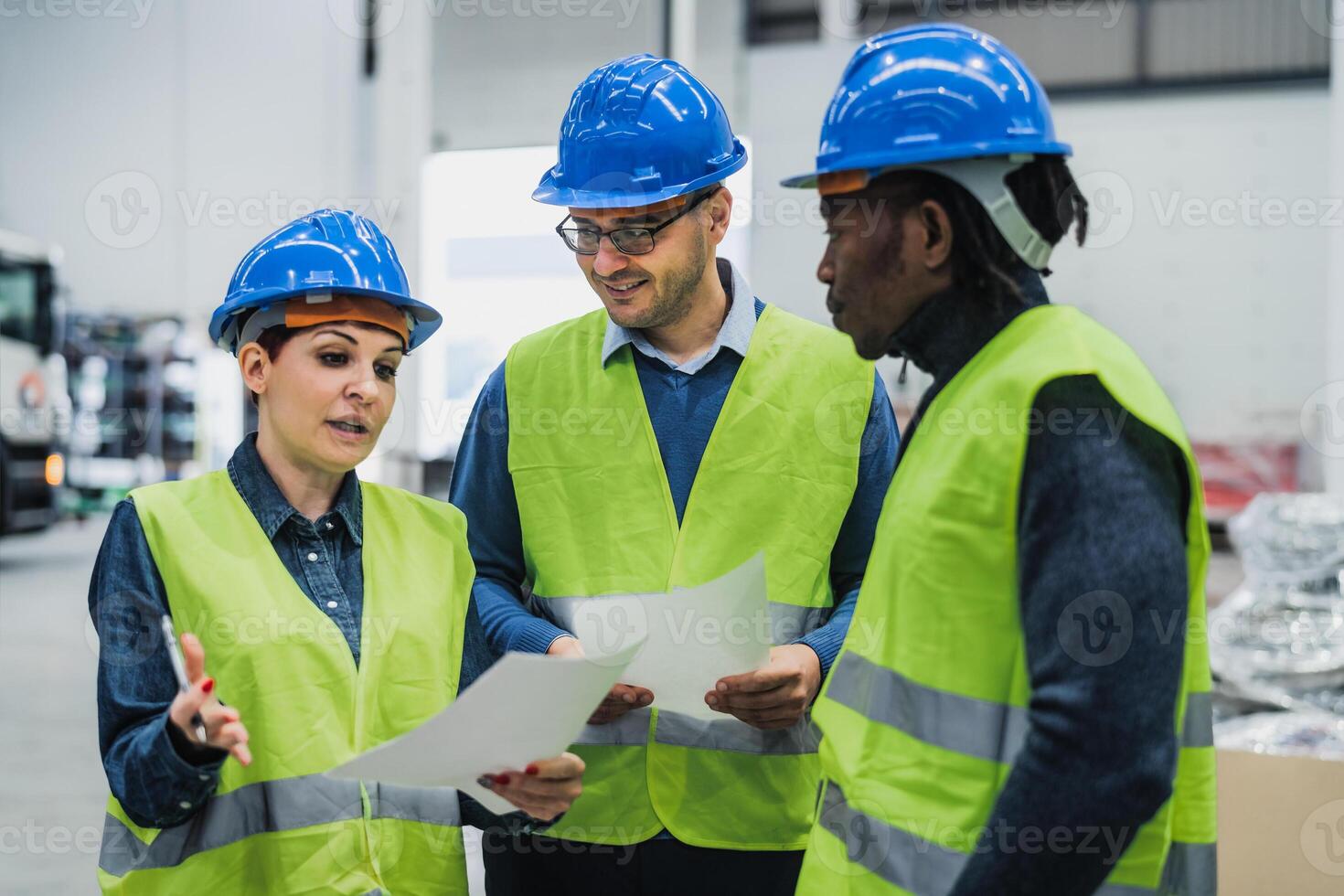 Team of multiracial engineers working in robotic factory - Tech industry concept photo