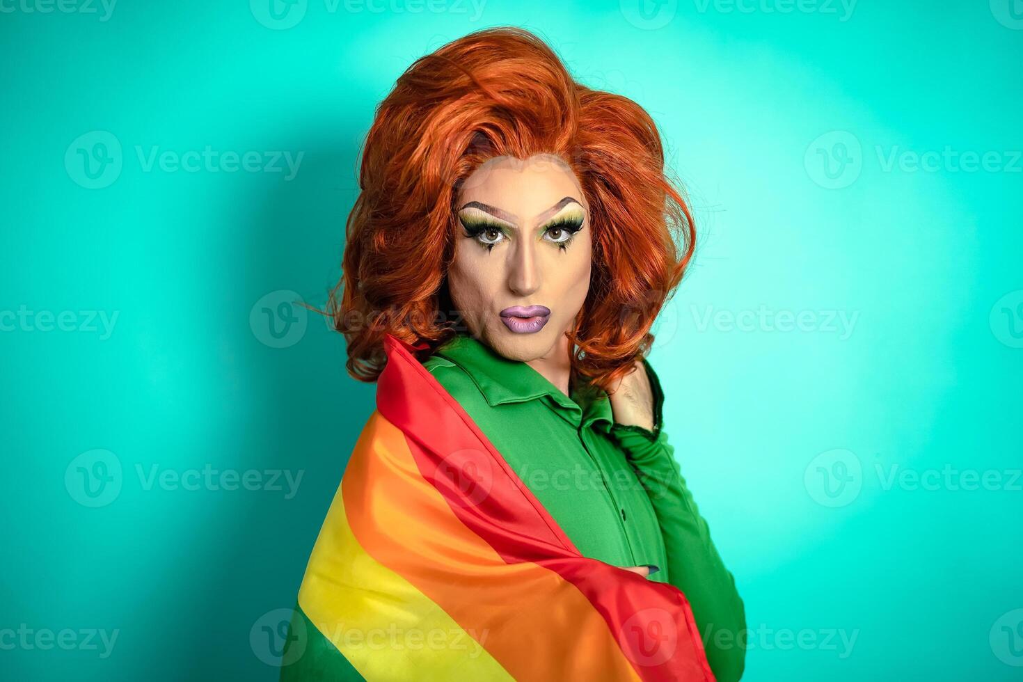 Happy drag queen celebrating gay pride holding rainbow flag - LGBTQ social community concept photo