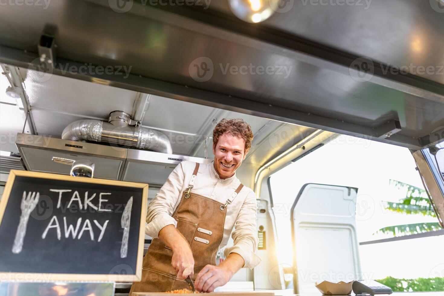 Food truck owner preparing meal recipe - Modern kitchen business and take away concept photo