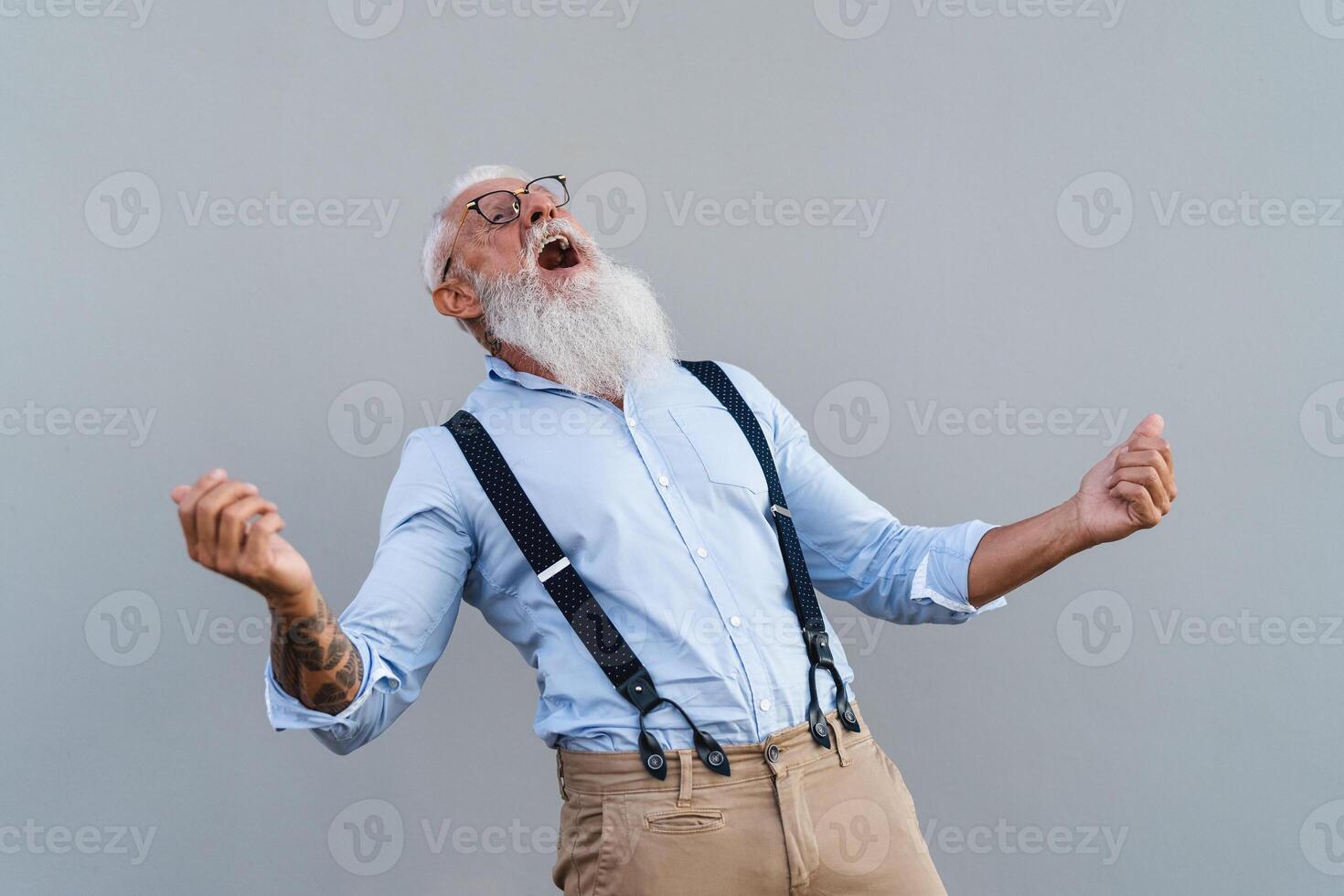 Happy trendy senior man having fun dancing in front camera - Fashion elderly male lifestyle concept photo