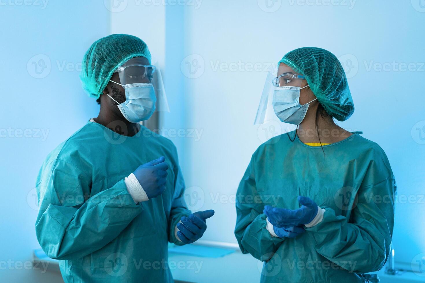 Doctors wearing personal protective equipment fighting against corona virus outbreak - Health care and medical workers concept photo