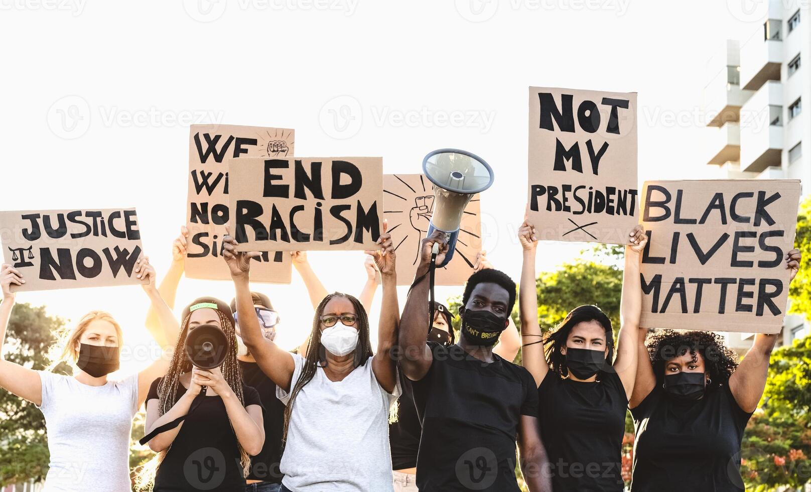 Activist movement protesting against racism and fighting for equality - Demonstrators from different cultures and race protest on street for equal rights - Black lives matter protests city concept photo
