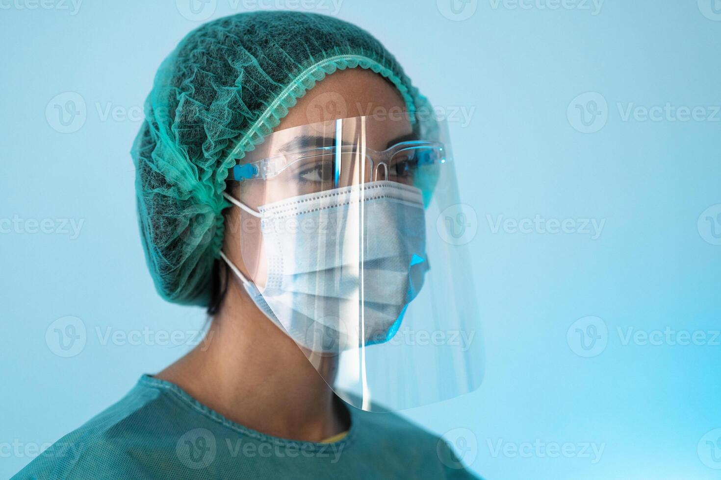 Young female doctor wearing personal protective equipment during corona virus pandemic - Health care worker concept photo