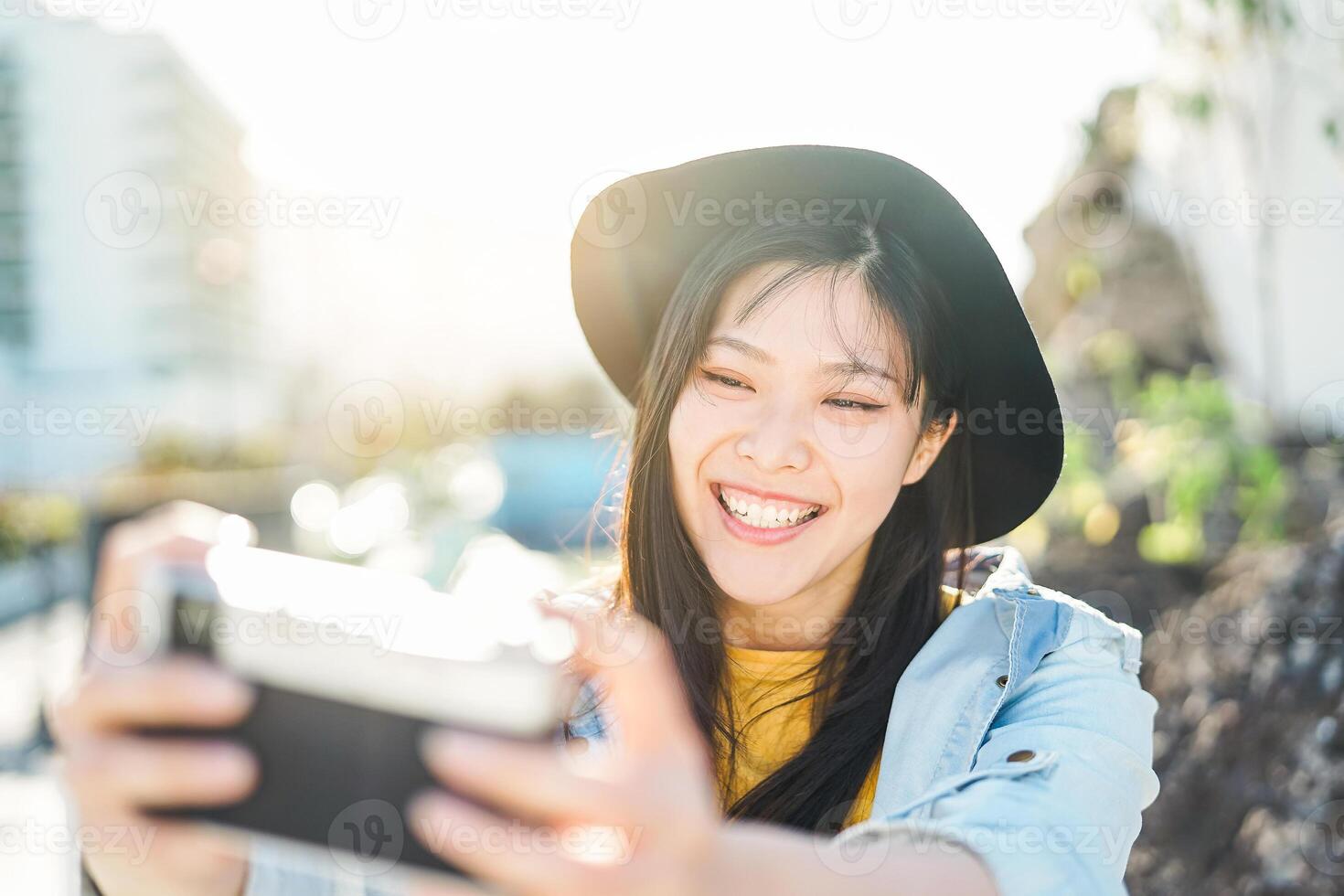 Happy Chinese influencer woman doing photo on vacation Young trendy
