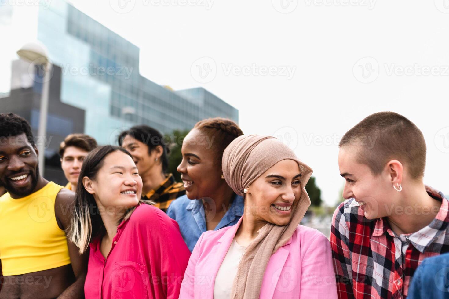 Young multiracial friends having fun together hanging out in the city - Friendship and diversity concept photo