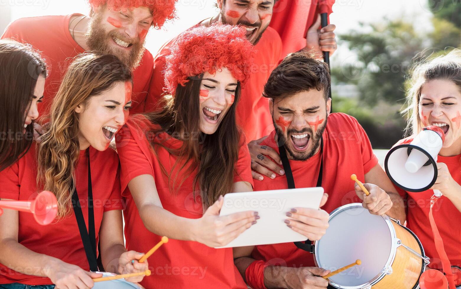 Friends football fans watching soccer match event on mobile digital tablet - Young crazy people having fun supporting club on sport world championship - Sport entertainment lifestyle concept photo