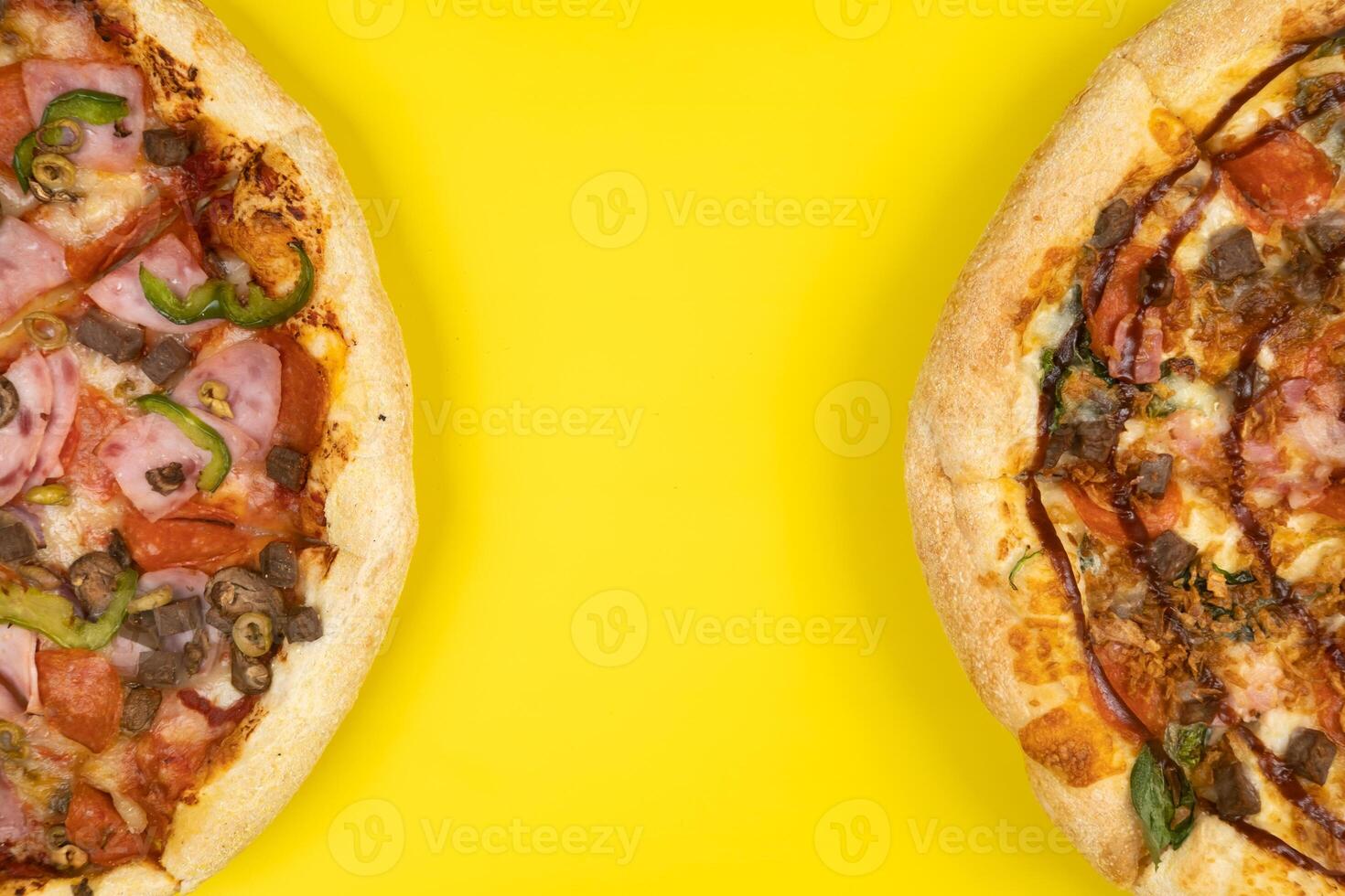 Two different Delicious big pizzas on a yellow background photo