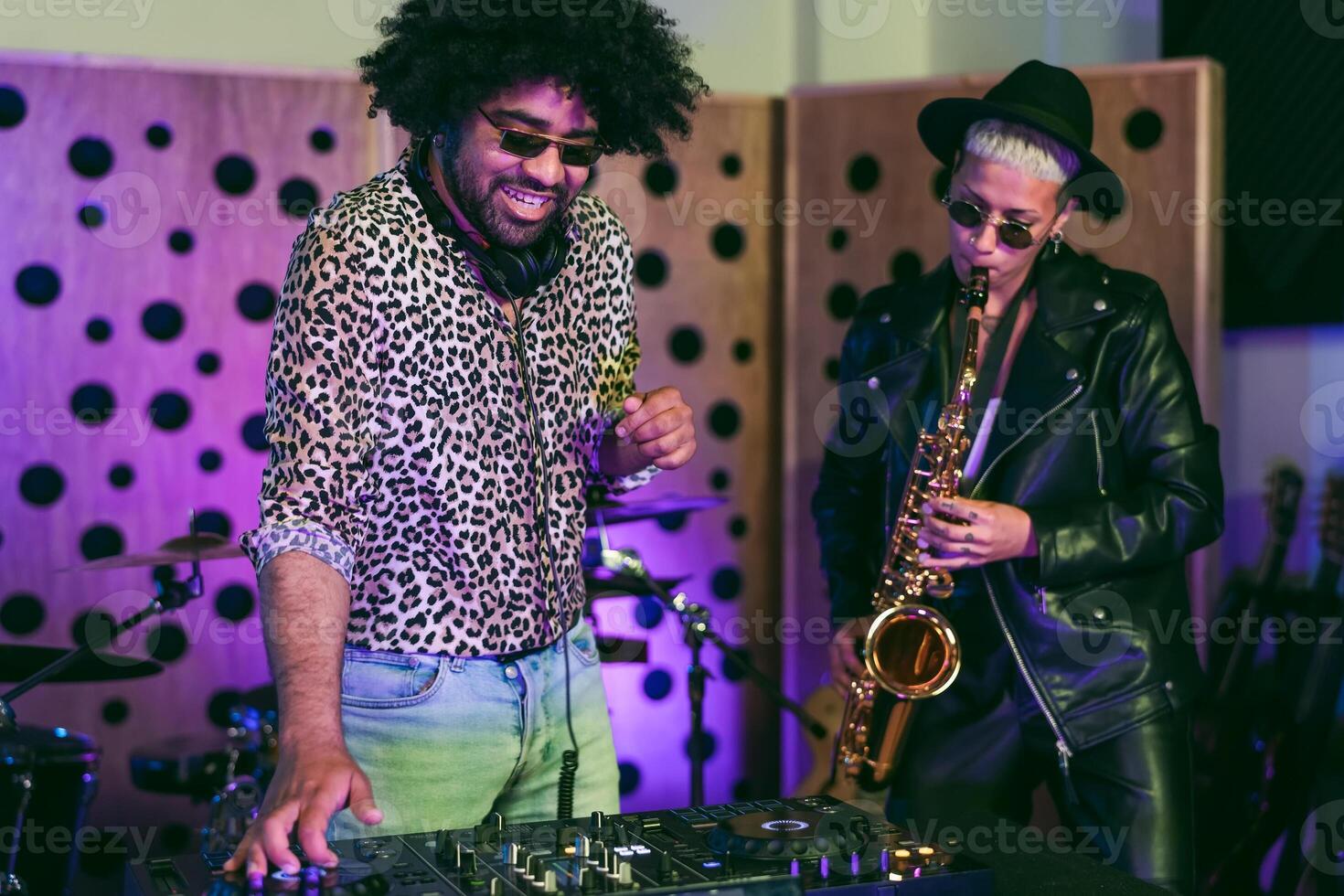 Young happy people playing music with dj mixer and saxophone in house studio - Youth musician entertainment concept photo