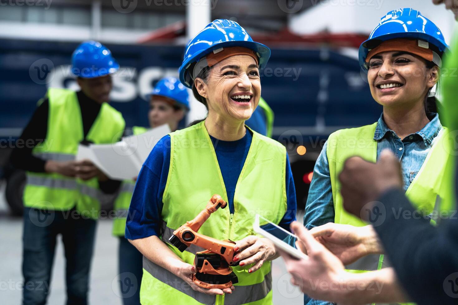 Team of engineers working in robotic factory - Tech industry concept photo