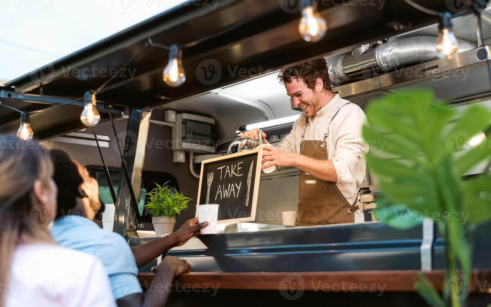 Happy multiracial people buying meal from street food truck market - Modern business and take away concept photo