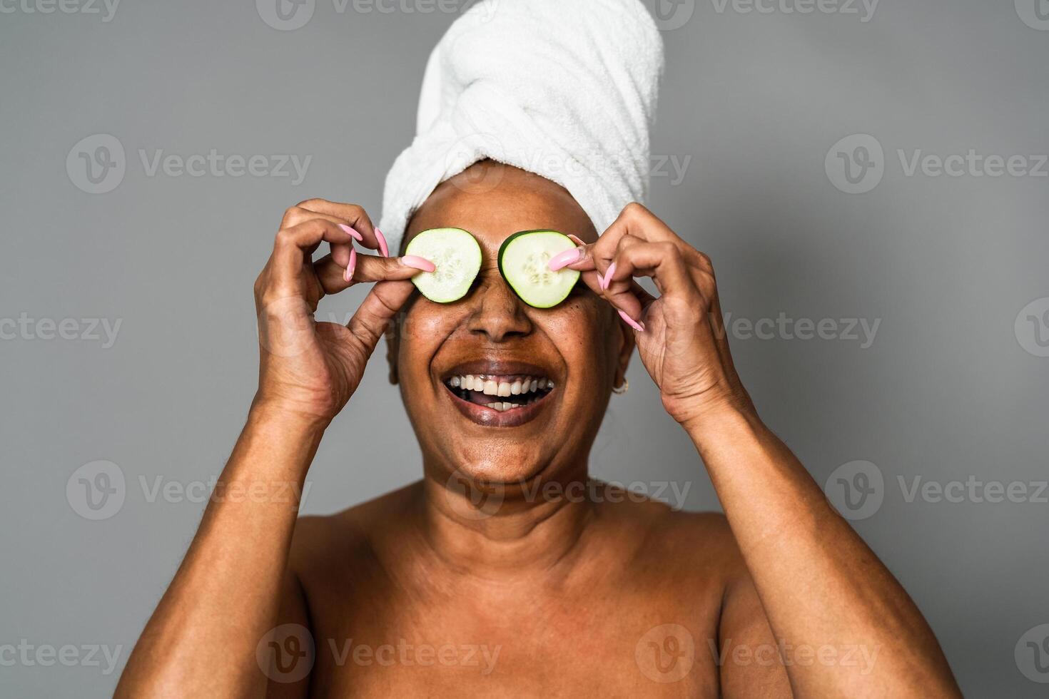 Happy African senior woman having skin care spa day - People wellness lifestyle concept photo