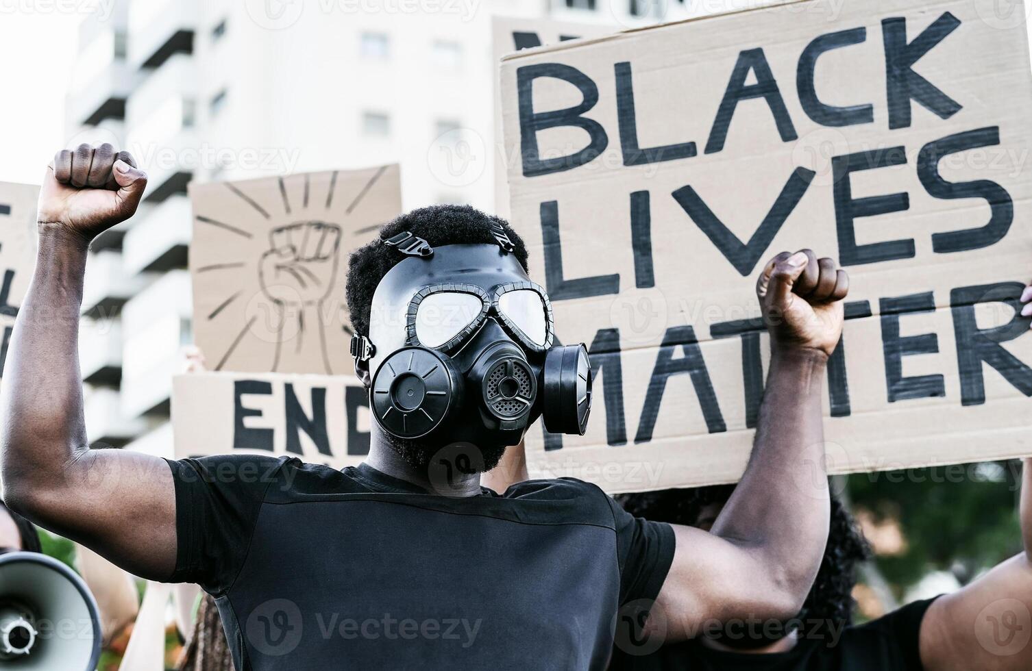 Activist wearing gas mask protesting against racism and fighting for equality - Black lives matter demonstration on street for justice and equal rights - Blm international movement concept photo