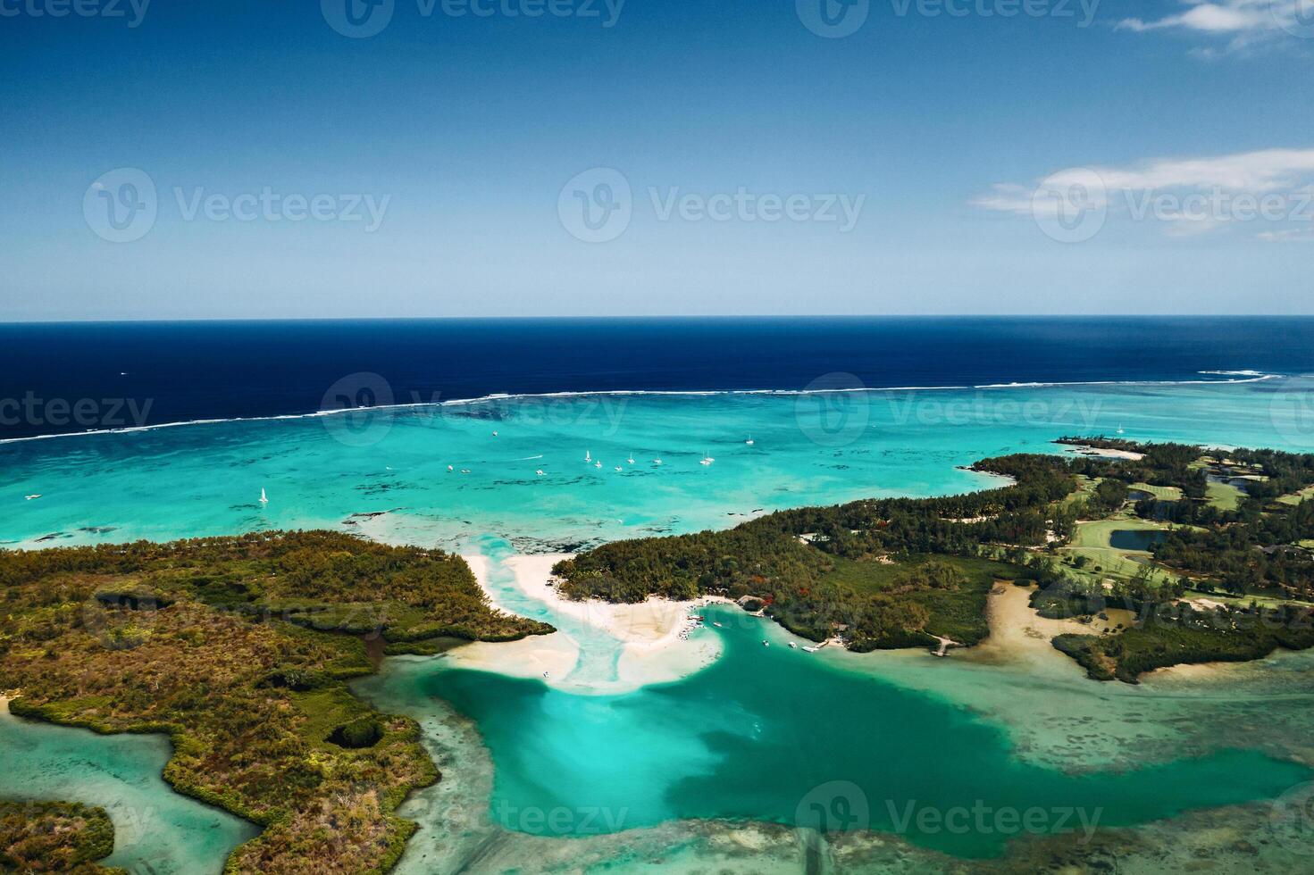 Aerial picture of the east coast of Mauritius Island. Beautiful lagoon of Mauritius Island shot from above. Boat sailing in turquoise lagoon photo