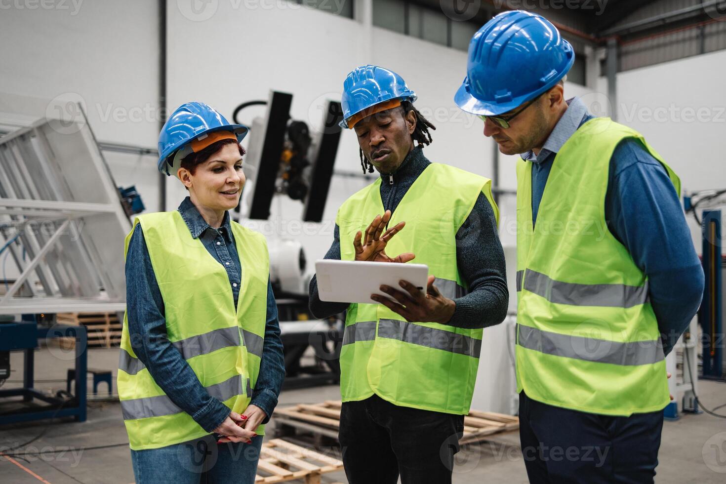 Team of engineers working in robotic factory - Tech industry concept photo