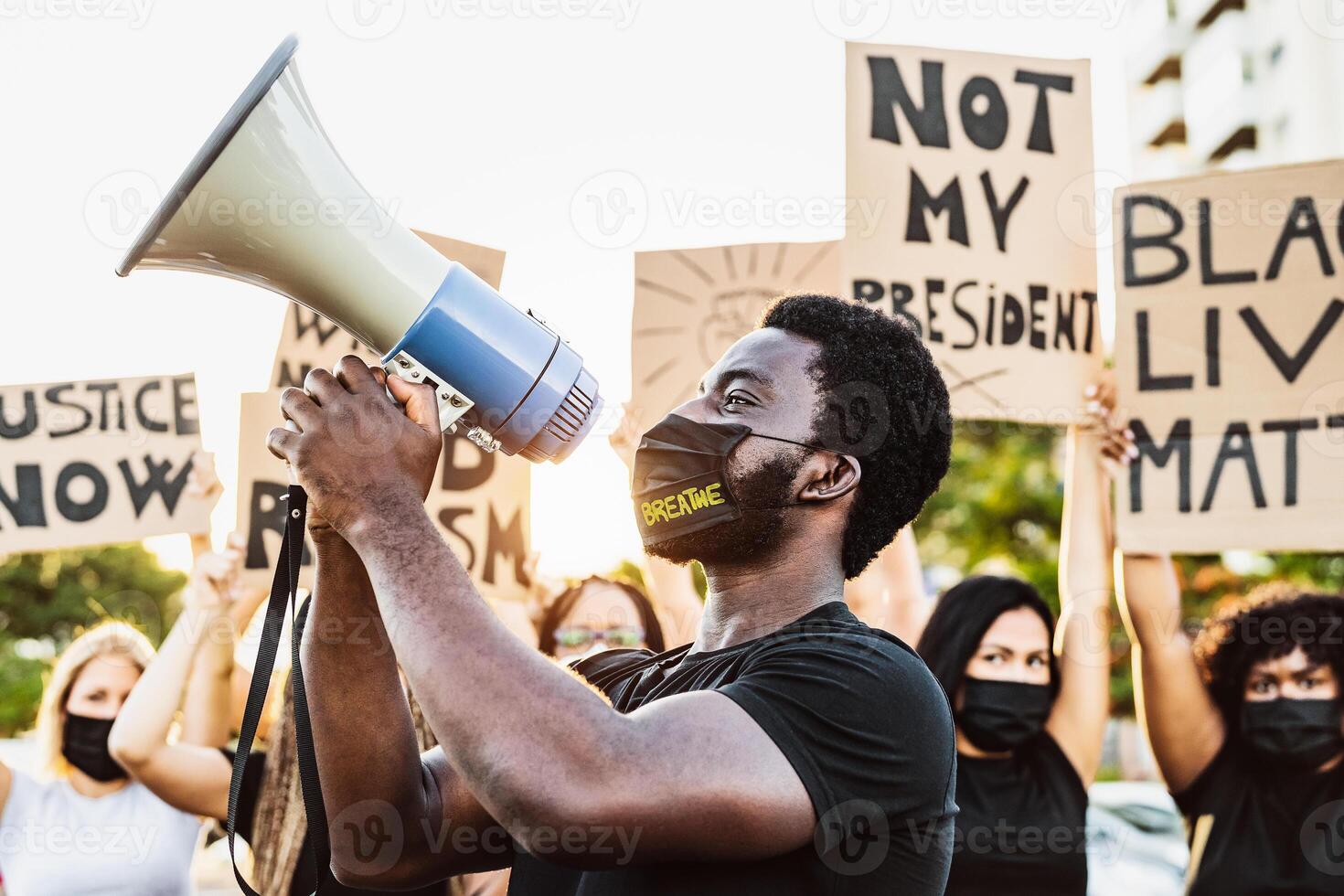 Black lives matter activist movement protesting against racism and fighting for equality - Demonstrators from different cultures and race protest on street for equal rights photo