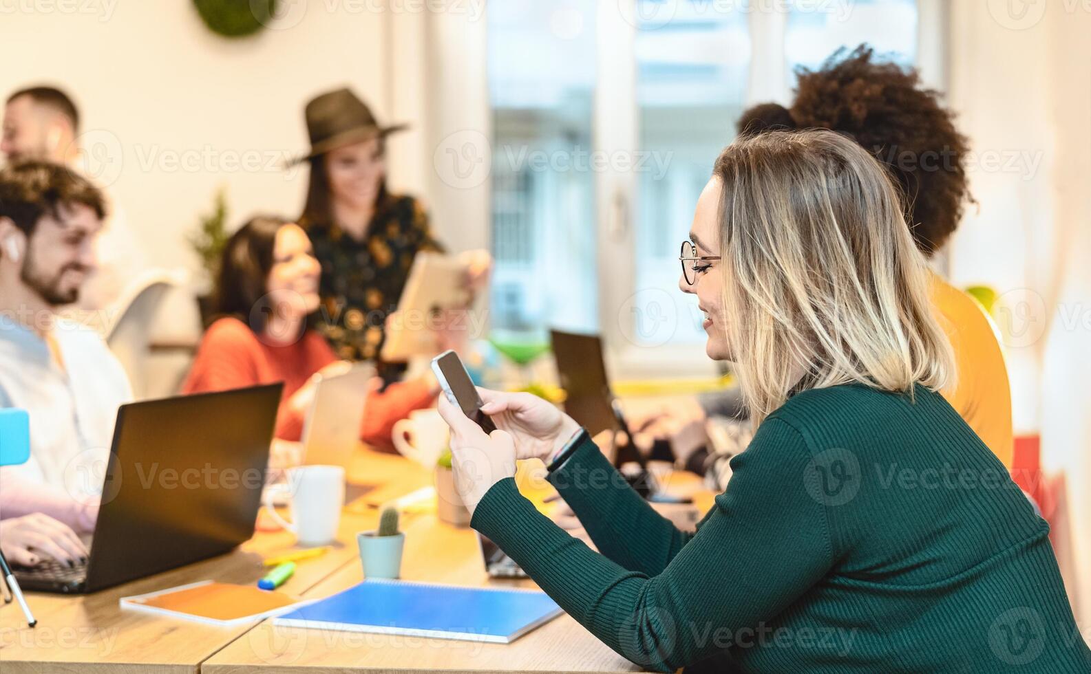 Young friends working together inside co-working creative space - Teamwork doing startup strategy in modern office - Youth millennial generation and technology concept photo
