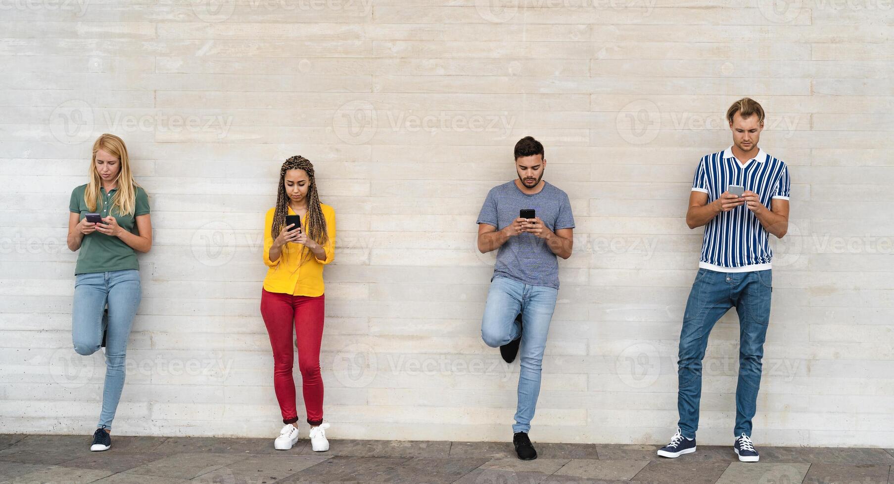 Young multiracial group of friends using mobile smartphone outdoor - Youth millennial lifestyle concept photo