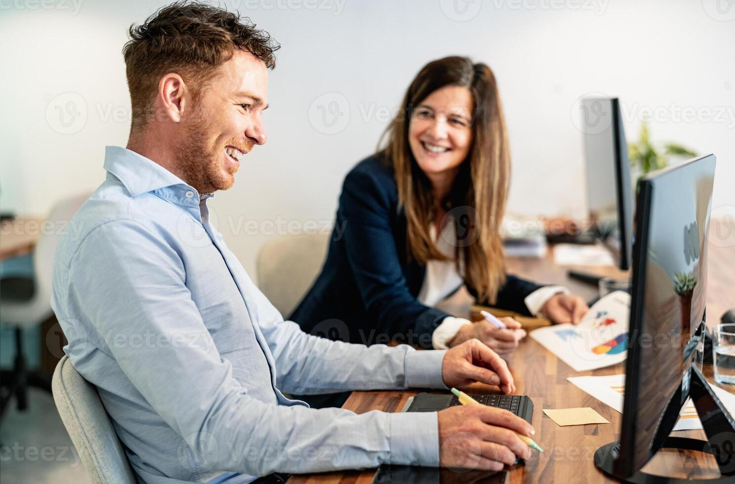 Happy digital content creators working in coworking creative space photo