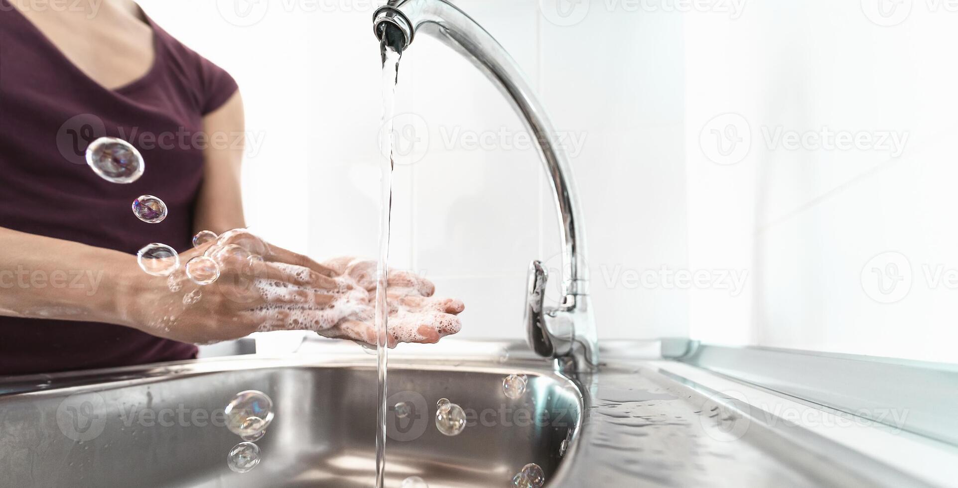 Female washing hands with liquid soap for preventing and stop corona virus spreading - Hygiene and healthcare people concept photo