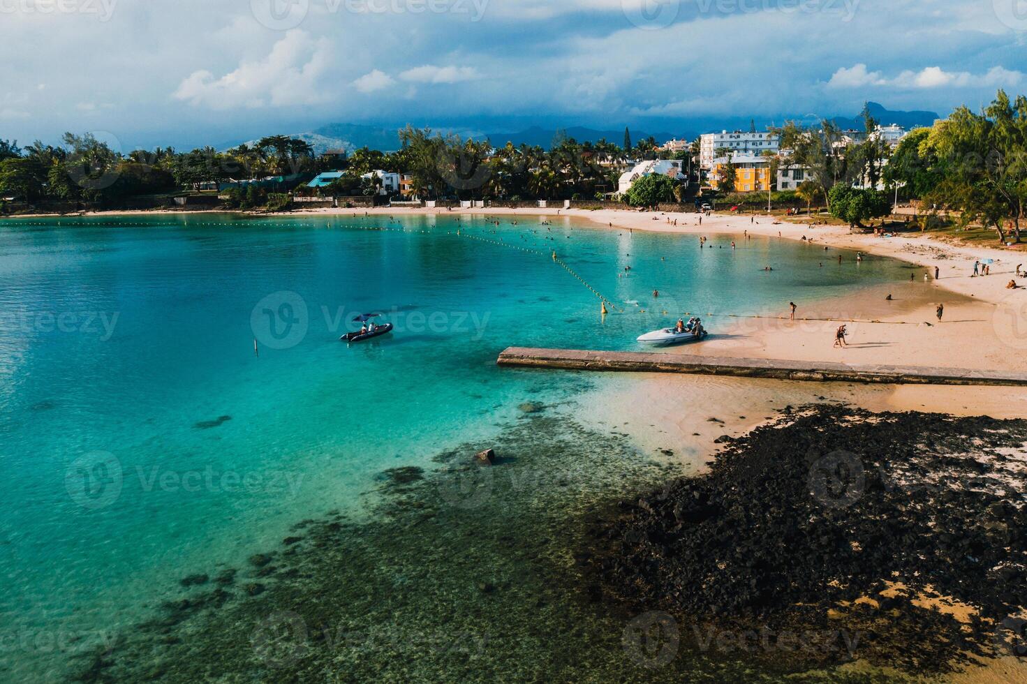 Aerial picture of the east coast of Mauritius Island. Beautiful lagoon of Mauritius Island shot from above. Boat sailing in turquoise lagoon photo