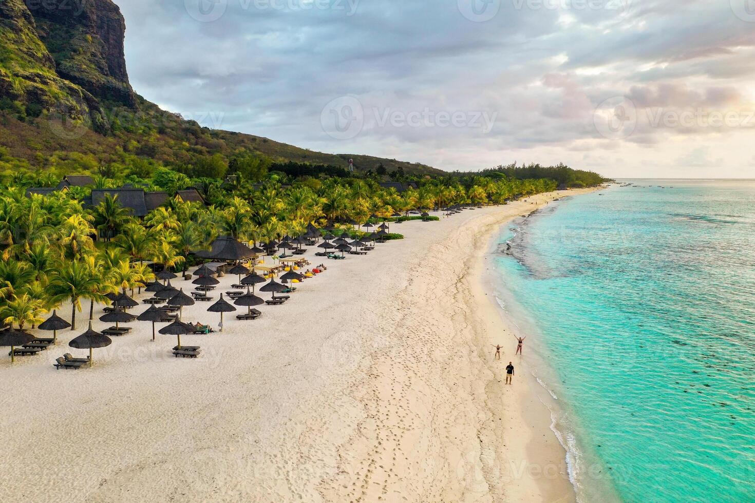 View from the height of the island of Mauritius in the Indian Ocean and the beach of Le Morne-Brabant and the family on the beach photo
