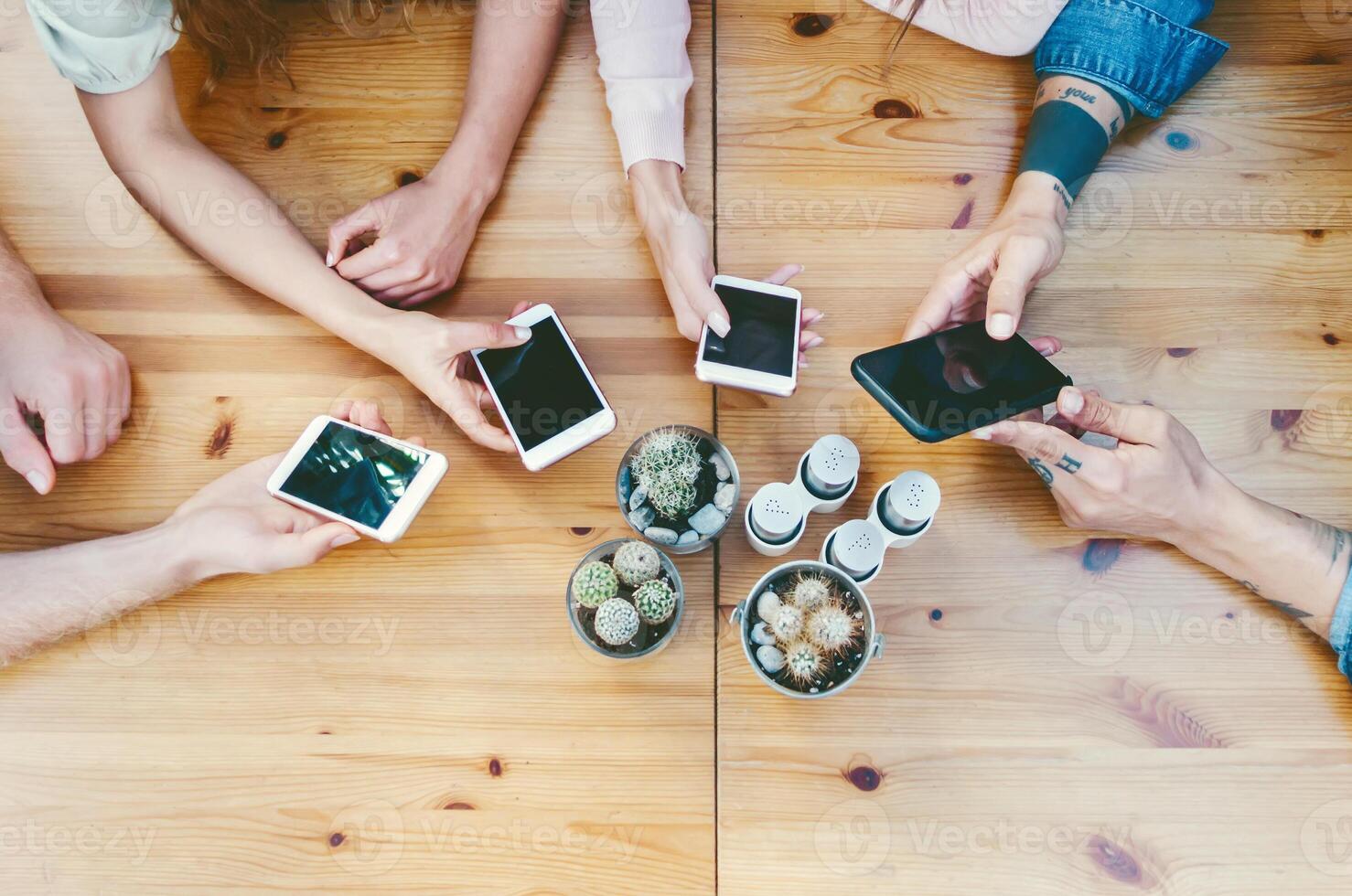 Group friends using mobile smartphones outdoor - Young people working on digital marketing - Youth millennial generation lifestyle and social media network technology concept photo