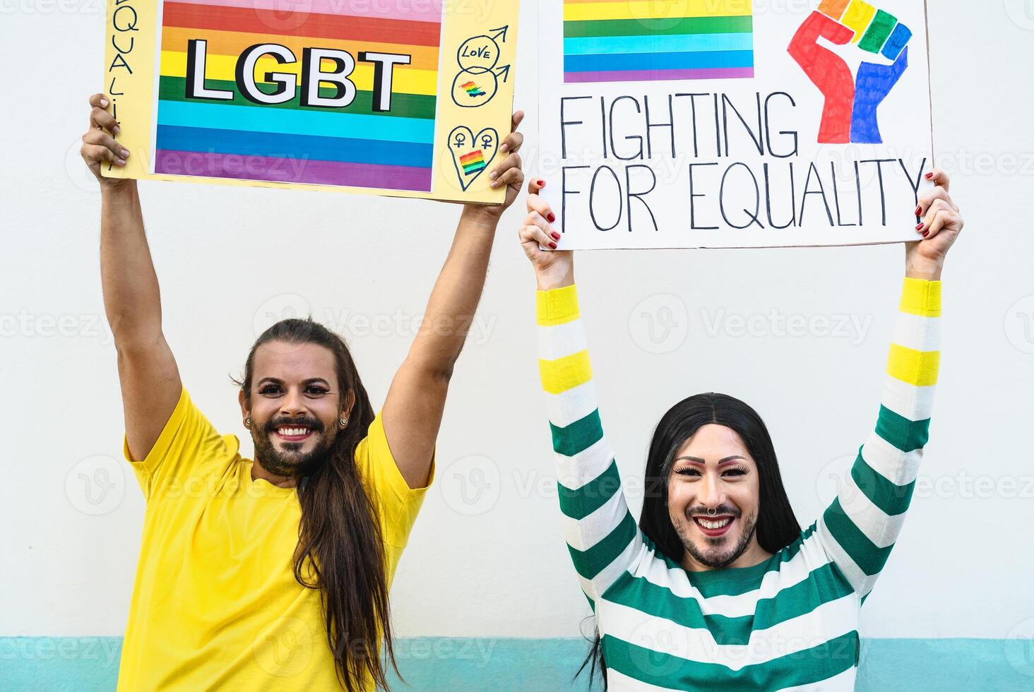 Happy drag queen activists protesting during gay pride parade - LGBT social movement concept photo