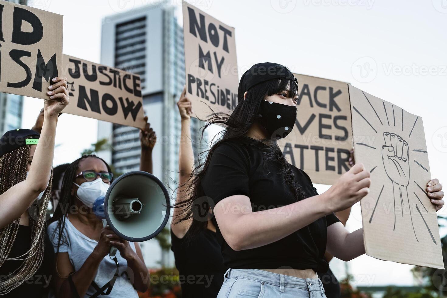 Activist movement protesting against racism and fighting for equality - Demonstrators from different cultures and race protest on street for equal rights - Black lives matter protests city concept photo