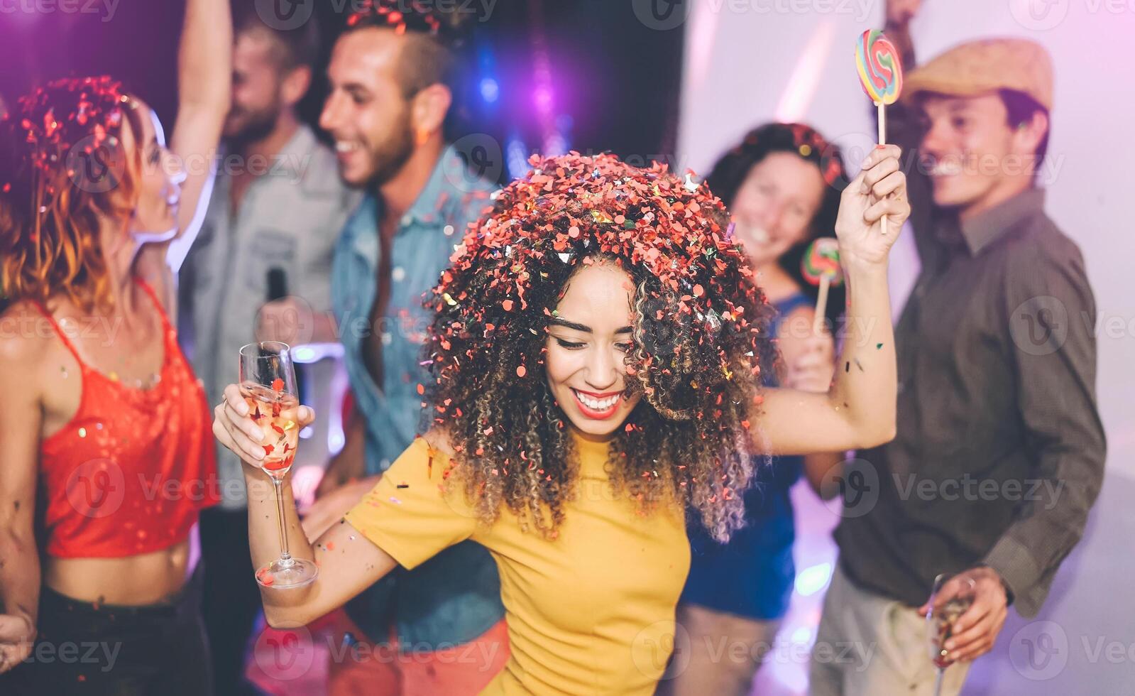 Happy friends doing party drinking champagne in nightclub - Group young people having fun celebrating new year holidays together in disco club - Youth entertainment lifestyle concept photo