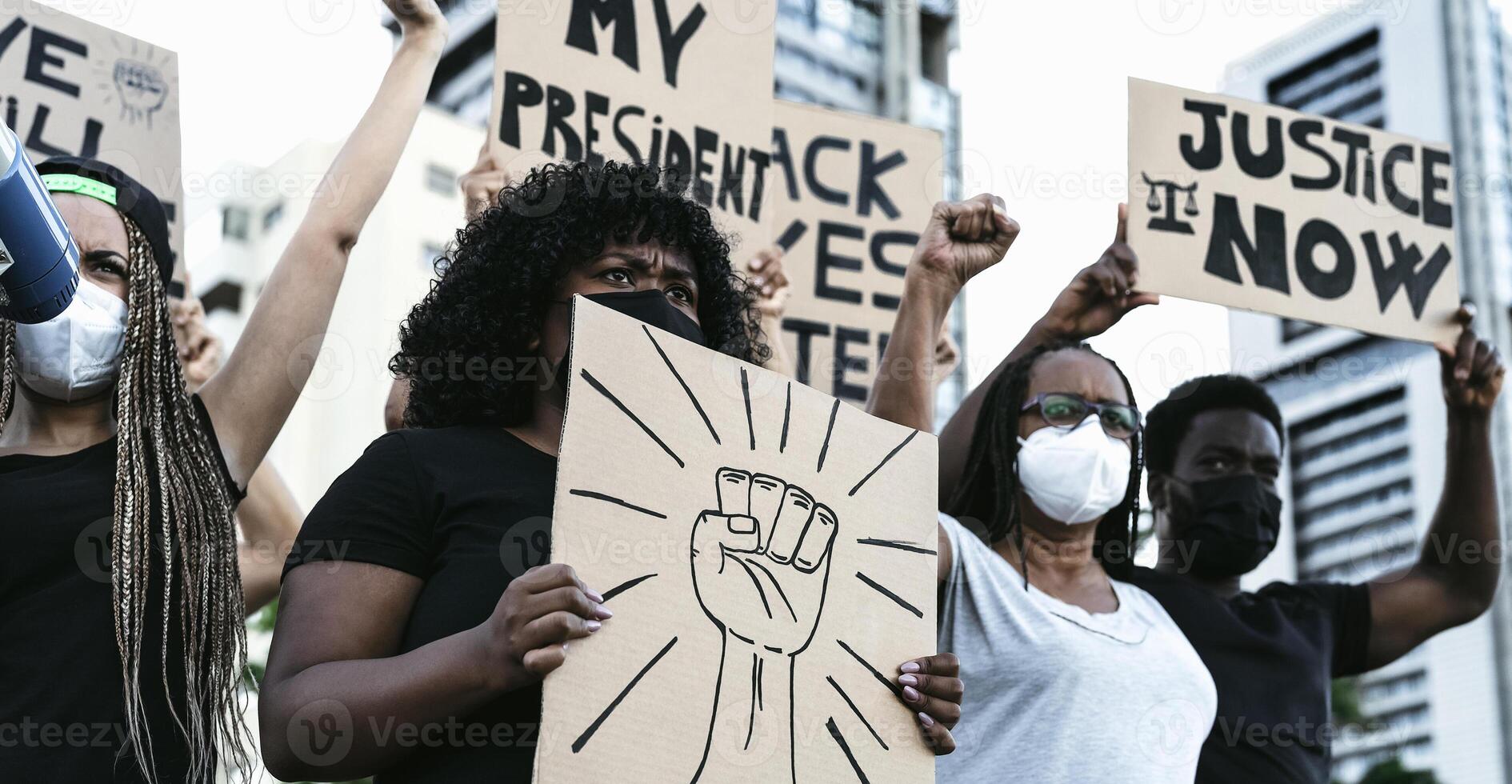 Activist movement protesting against racism and fighting for equality - Demonstrators from different cultures and race protest on street for equal rights - Black lives matter protests city concept photo