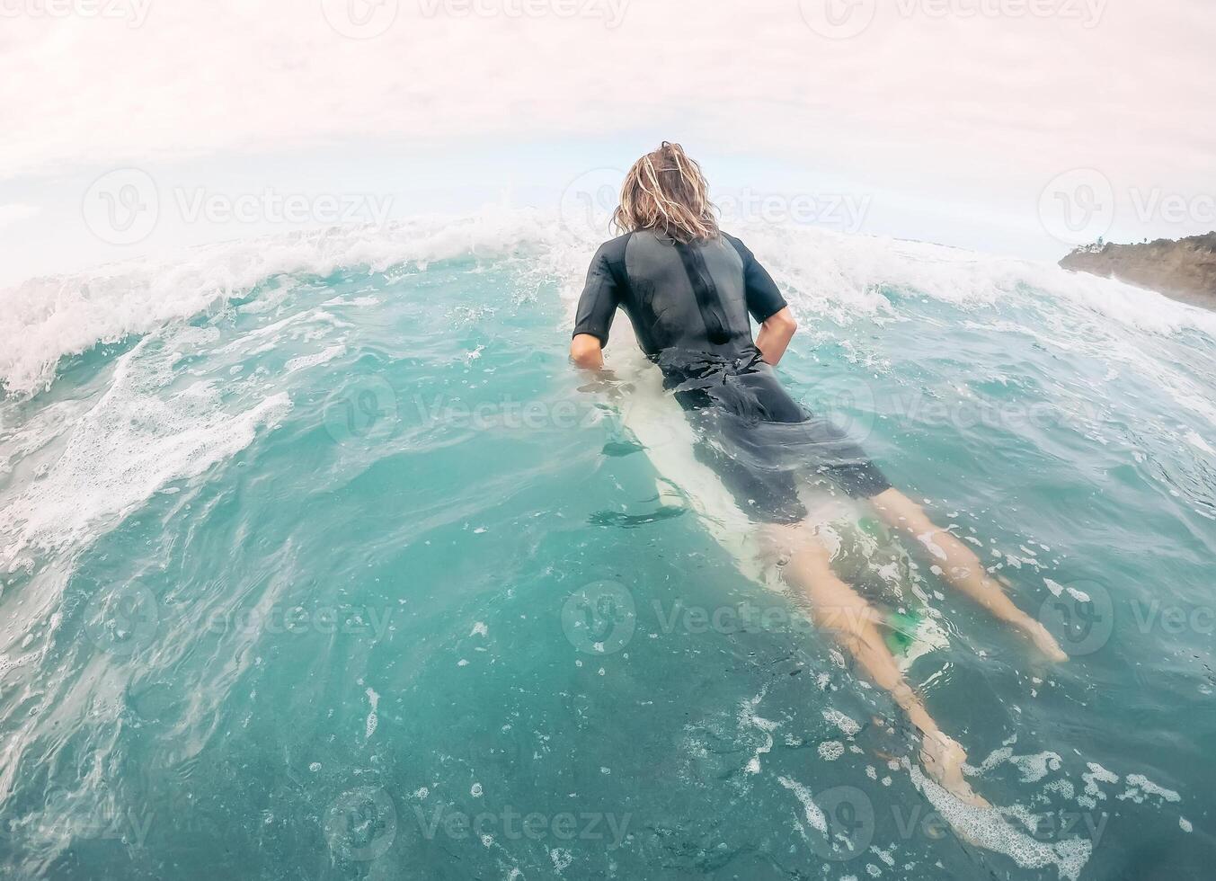 Young man having fun surfing on high waves ocean - Sporty surfer doing training exercises on blue water - Extreme sport and health vacation lifestyle people photo