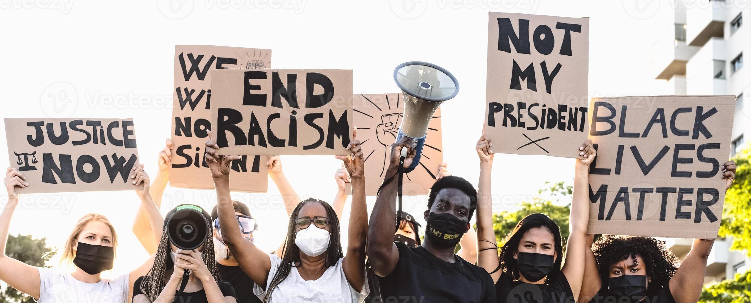 Activist movement protesting against racism and fighting for equality - Demonstrators from different cultures and race protest on street for equal rights - Black lives matter protests city concept photo