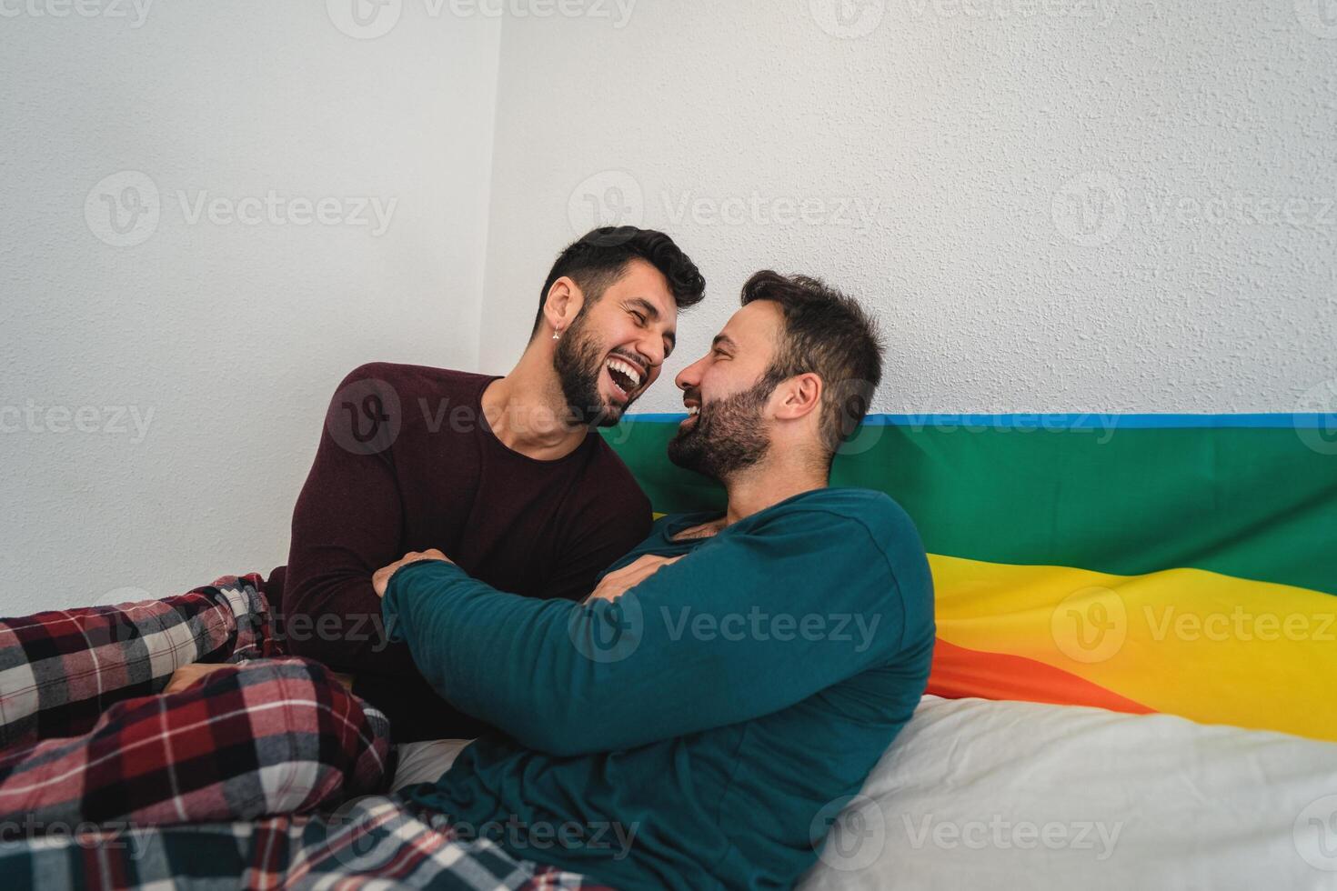 Happy gay couple having tender moments in bedroom - Homosexual love relationship and gender equality concept photo