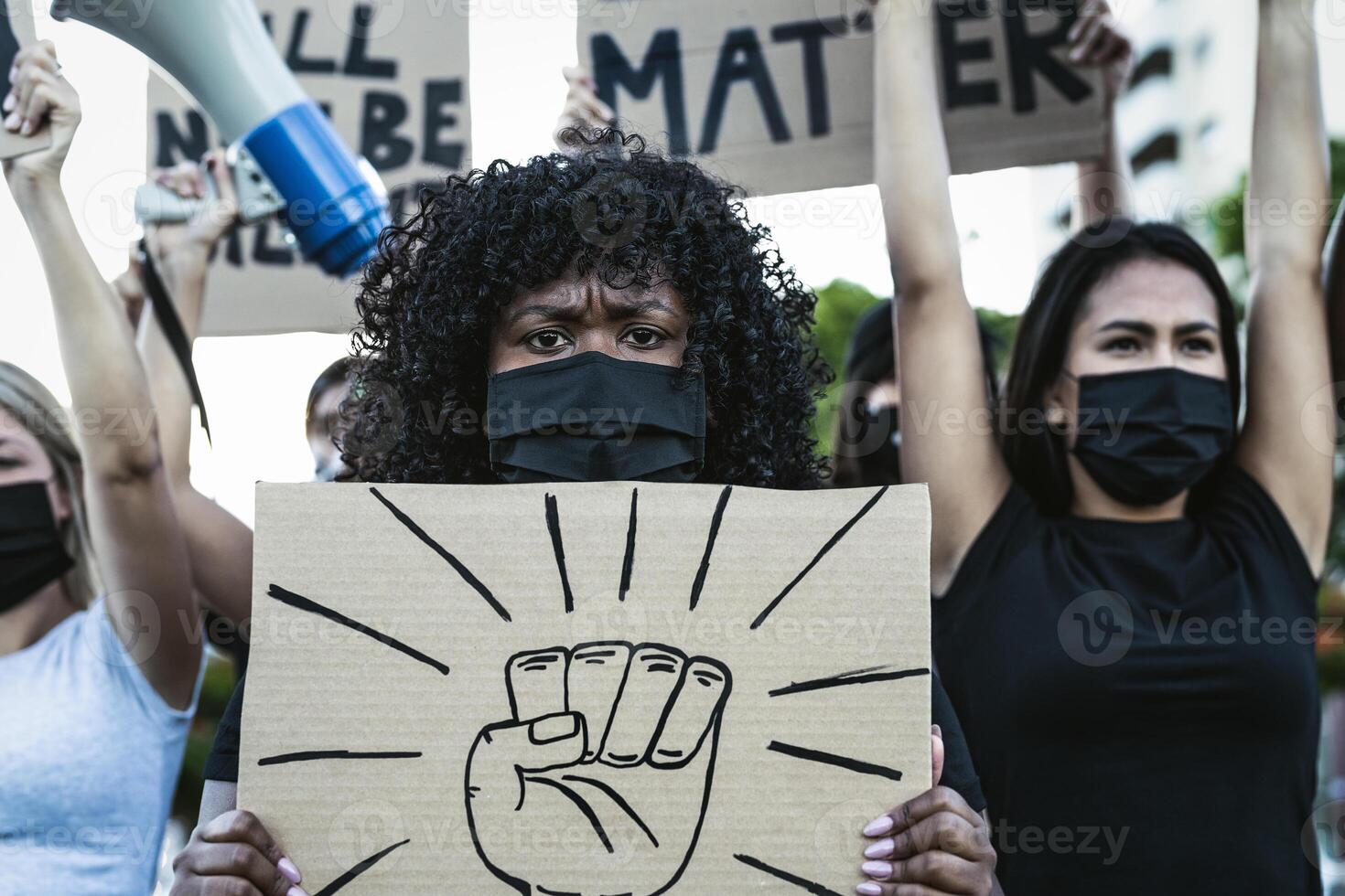 Black lives matter activist movement protesting against racism and fighting for equality - Demonstrators from different cultures and race protest on street for justice and equal rights photo