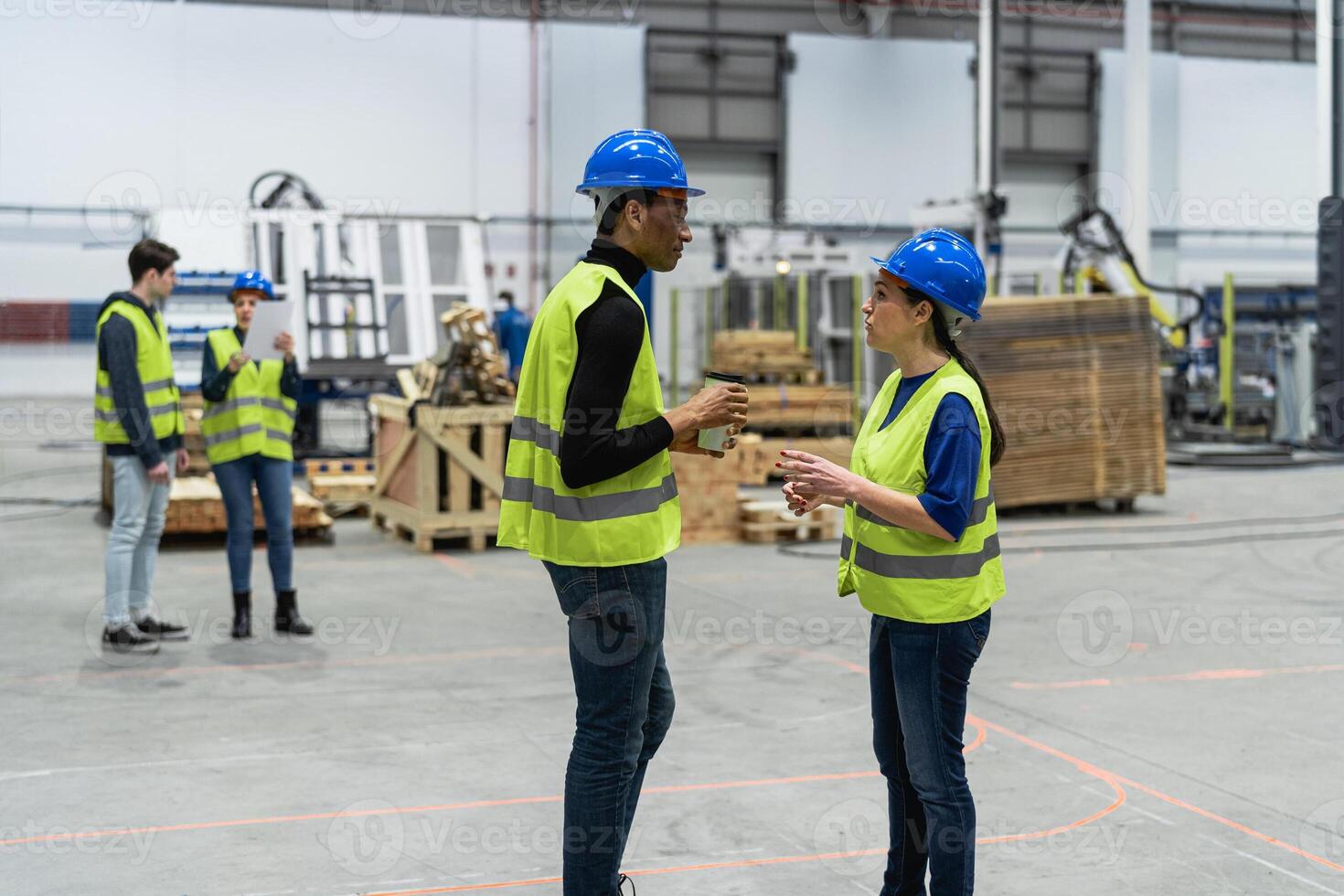 Team of multiracial engineers working in robotic factory - Tech industry concept photo