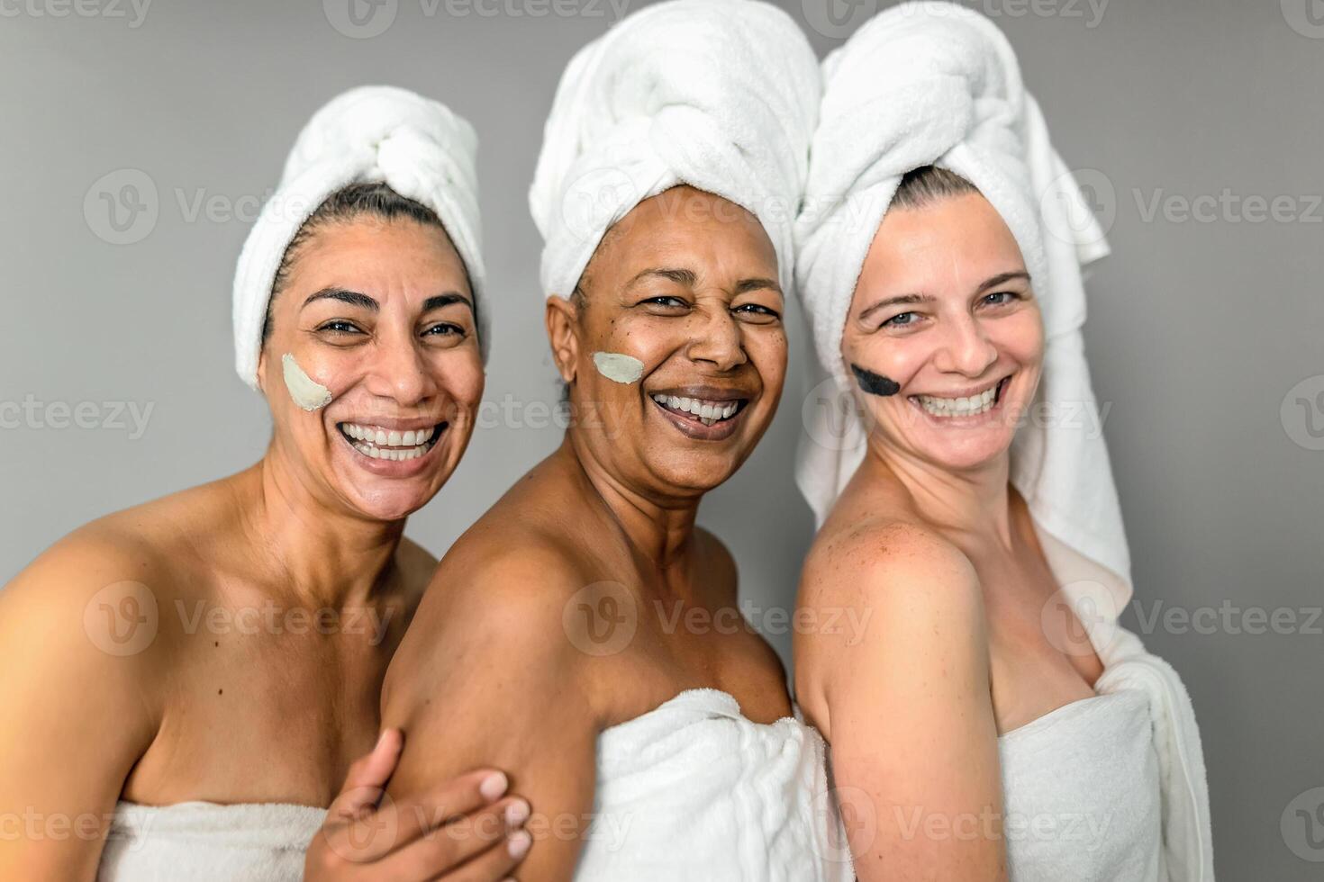 Happy multiracial senior women having skin care spa day - People wellness lifestyle concept photo