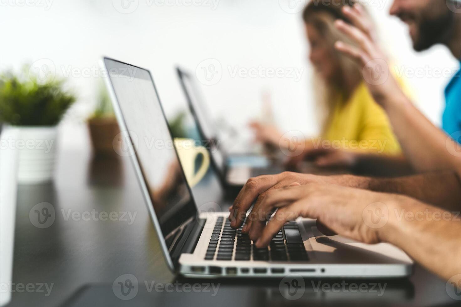 Young friends working together inside co-working creative space - Teamwork doing startup strategy in modern office - Youth millennial co-workers generation and technology concept photo