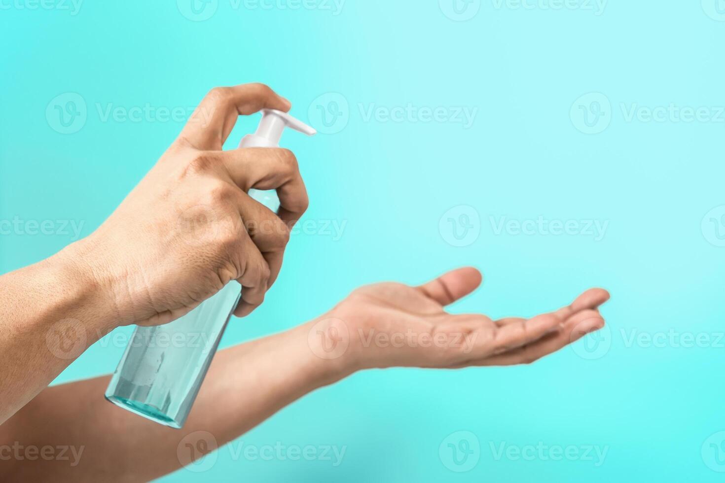 People cleaning hands with antiseptic alcohol gel - Female using disinfectant for preventing corona virus spreading - Hygiene and health care concept - Aquamarine background photo