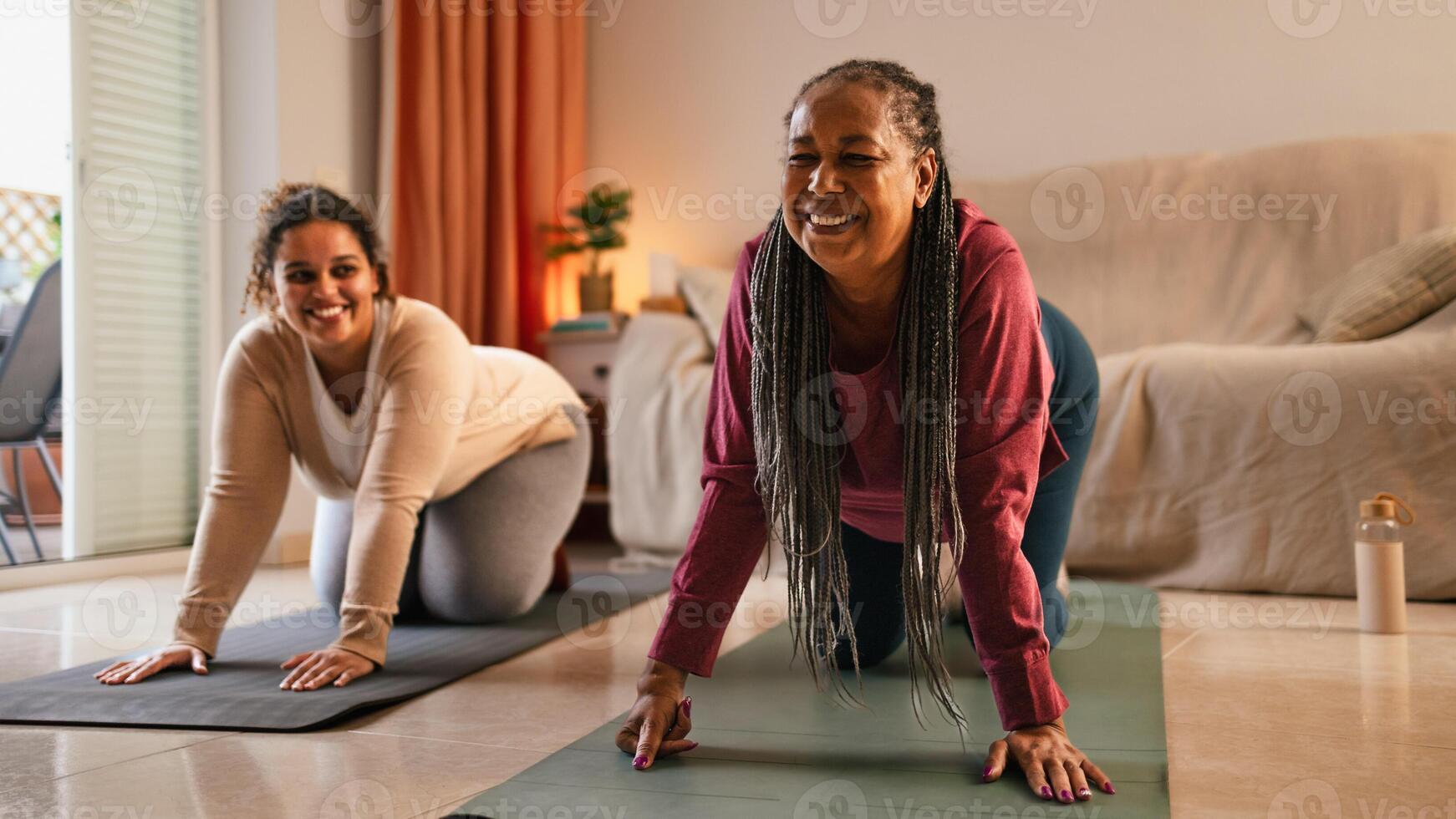 Happy mother with daughter doing exercises at home photo