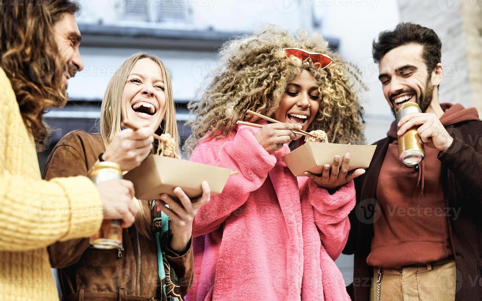 Young multiracial friends having fun eating street food and drinking beer - Youth millennial lifestyle concept photo