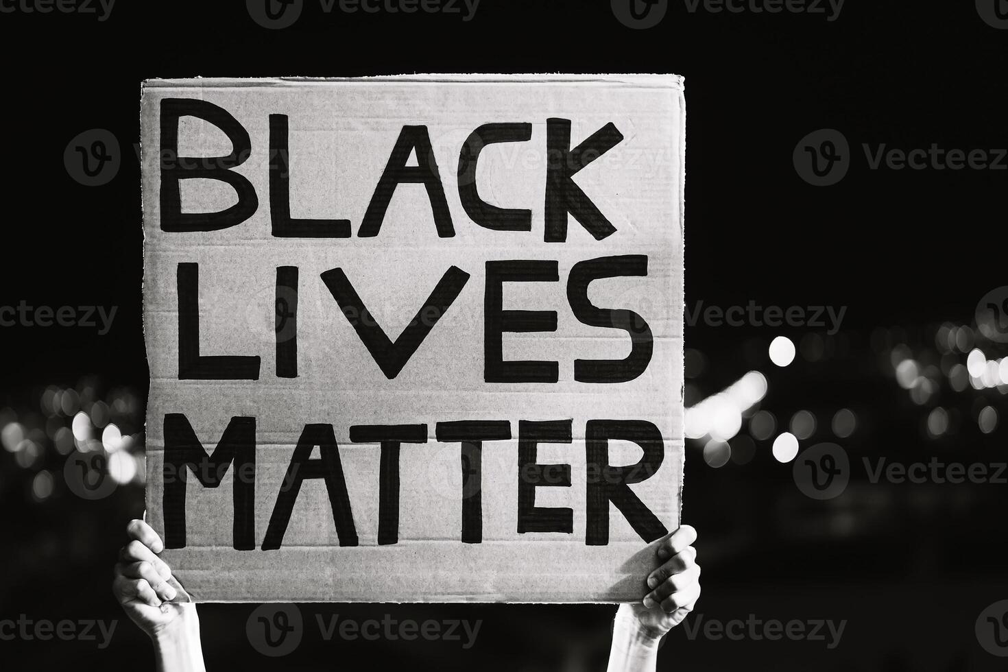 Black lives matter banner - Activist movement protesting against racism and fighting for equality - Social protests and human rights concept - Black and white editing photo
