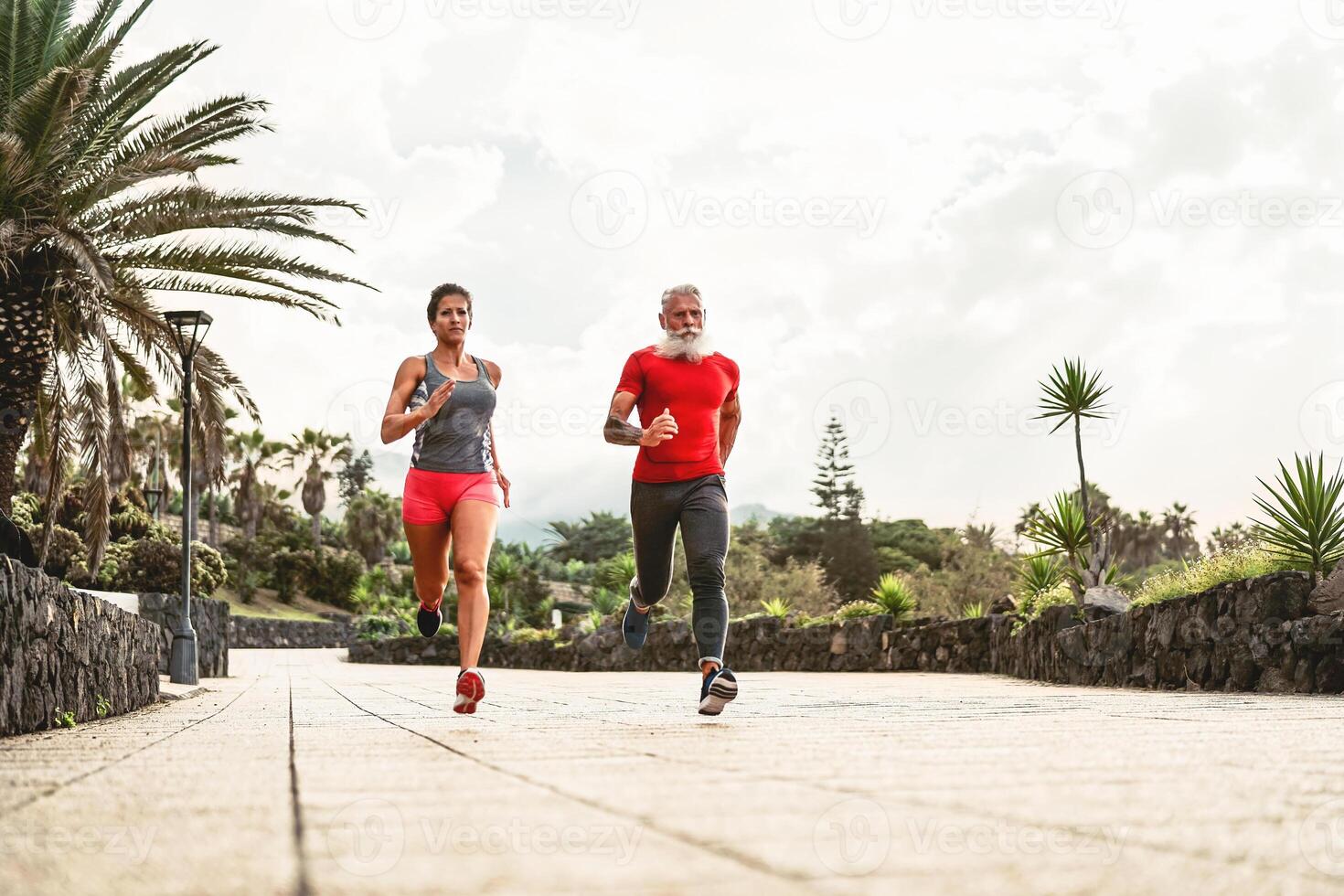 Fit friends running together in park outdoor - Sporty people doing workout sprint exercises outside - Fitness, jogging and health training lifestyle concept photo