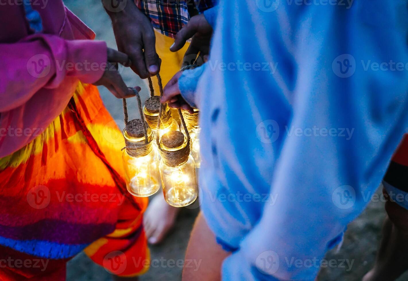 Hipster friends having fun while camping with tent on the beach - Young people holding bright lanterns in campsite on summer - Concept of friendship, travel, vacation and youth lifestyle photo