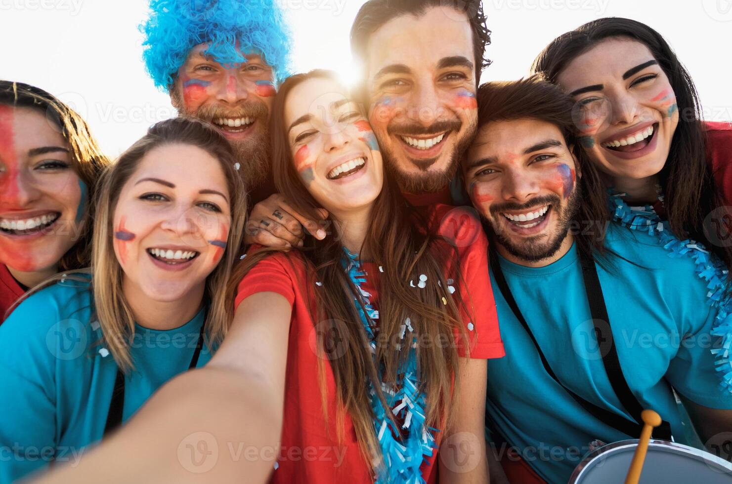 Football fans taking selfie during the soccer match event at stadium - Young people having fun supporting favorite club - Sport entertainment concept photo